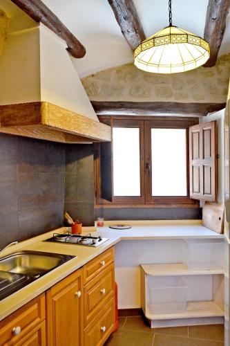 a kitchen with a sink and a stove at Casa Manolita in Calaceite