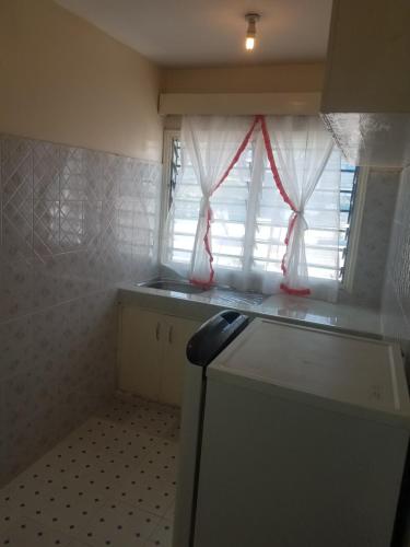 a small kitchen with a window and a counter at Ocean View Nyali Boutique Hotel in Nyali