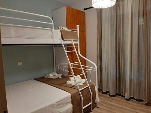 a small room with a bunk bed with a ladder at Σιντηίς- Sinties in Moudhros