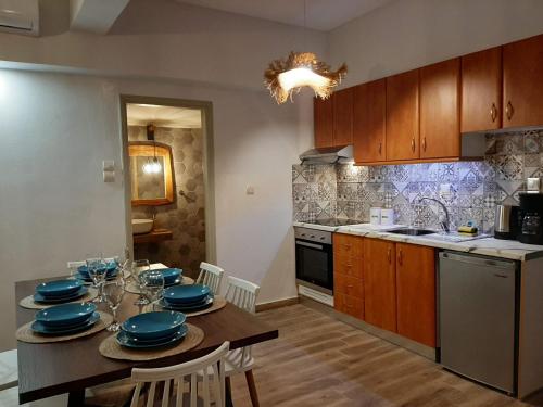 a kitchen with a table with blue dishes on it at Σιντηίς- Sinties in Moudhros