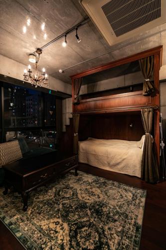 a bedroom with a bed and a piano in it at Creare Ryogoku in Tokyo