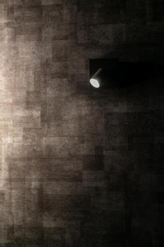 a light in a room with a brick wall at Creare Ryogoku in Tokyo