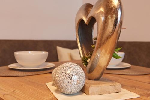 a table with a heart shaped sculpture on a table at Frühstückspension Klinglhub in Flachau