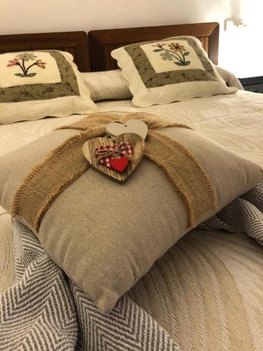 a bed with a blanket with a heart on it at Apartamento Islas Medas WIFI y PARKING GRATIS in L'Estartit