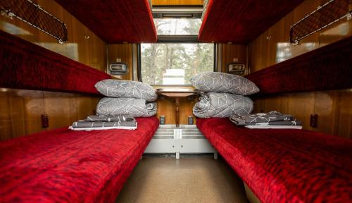 two beds in the back of a train room at Palanga Camping Hostel in Palanga
