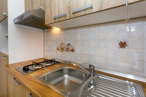 a kitchen with a sink and a stove at Lovely Sea View House in Malinska Island Krk in Malinska
