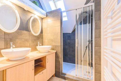 a bathroom with two sinks and a shower at Suite PREMIUM LE FIGARO 2 in Épernay