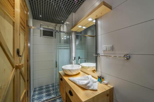 a bathroom with two sinks and a mirror at İksirci Baba Hotel in Oludeniz