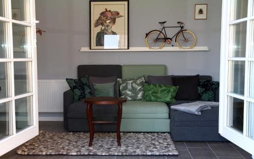 a living room with a couch and a bike on the wall at Landlust Unser L ieblingscafe in Xanten