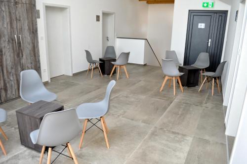 a room with chairs and a whiteboard in a room at Vinařství Herůfek in Zaječí