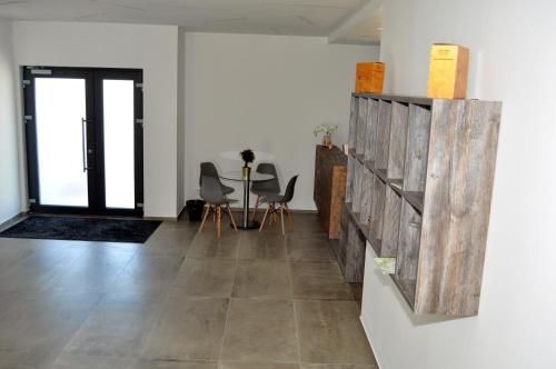 a living room with a table and chairs at Vinařství Herůfek in Zaječí