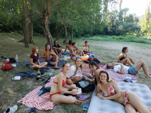 a group of people sitting on blankets in a park at Hostel Dalmatia in Marusici 