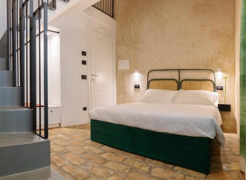 Krevet ili kreveti u jedinici u okviru objekta OGNISSANTI GuestHouse & Suites
