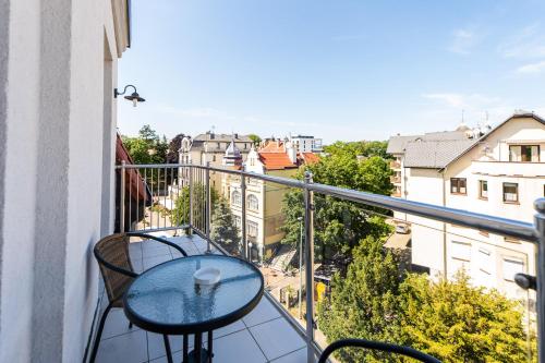 a balcony with a table and a view of a city at Marina in Międzyzdroje