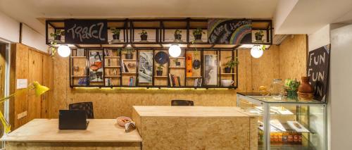a restaurant with a table and a shelf with pictures at Locul Central - Church Street in Bengaluru