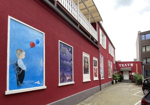 a red building with paintings on the side of it at Hotelik Gdanska in Oberhausen
