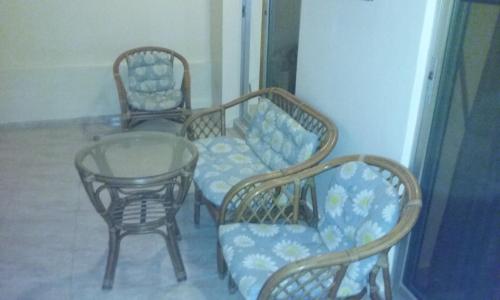 three chairs and a table and a table and chairs at Kitesurf Paradise Studios in Theologos