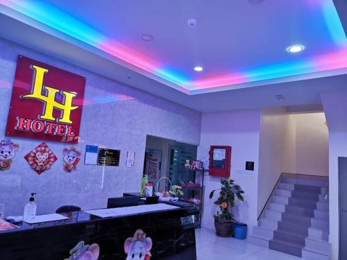 a hotel room with a neon sign and stairs at LH Hotel Langkap Perak in Kampung Degong