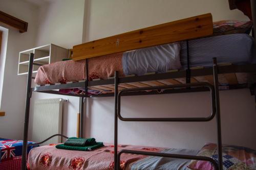 two bunk beds in a room with a bed at CasaSabry in San Nicolò di Comelico