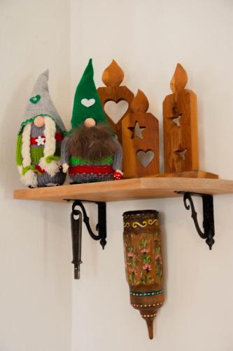 a wooden shelf with stuffed animals on a wall at CasaSabry in San Nicolò di Comelico