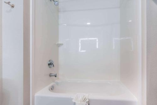 a bathroom with a shower and a white tub at La Quinta Inn and Suites by Wyndham Houston Spring South in Spring