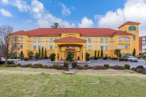 a large yellow building with a red roof at La Quinta by Wyndham Fultondale Birmingham North in Fultondale