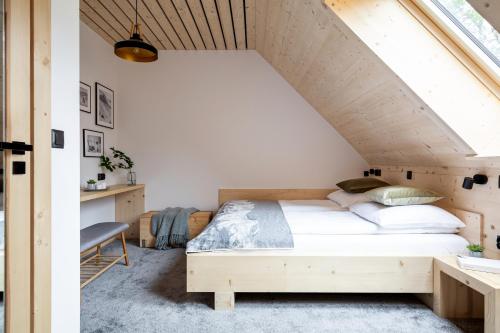 a bedroom with a wooden bed in a attic at Mount Apart Center in Zakopane