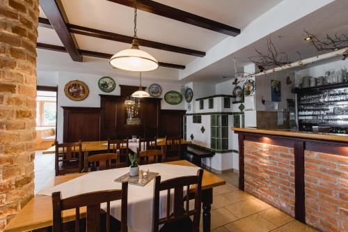 a restaurant with tables and chairs and a bar at Gasthaus Hotel Ostermeier in Attenkirchen