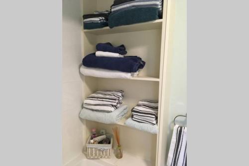 a towel rack with towels in a bathroom at 4 bed family house with aga in Battle