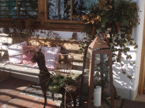 a porch with a bench and a lamp at Landhaus Am Arzbach in Bad Tölz