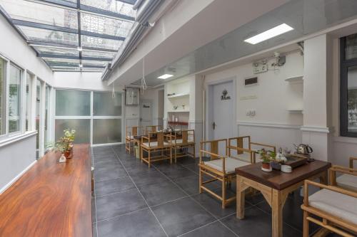 an empty room with tables and chairs in a building at Guilin Flowers Inn in Guilin