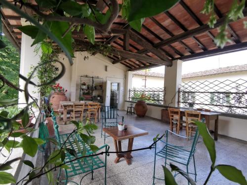 a patio with chairs and a table in a building at Agriturismo La Fattoria di Capezzana in Carmignano