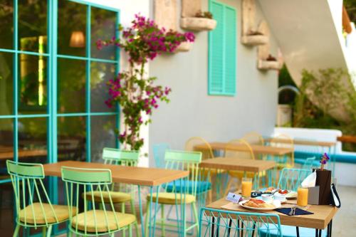a row of tables and chairs in a restaurant at Illyrian Boutique Hotel in Sarandë