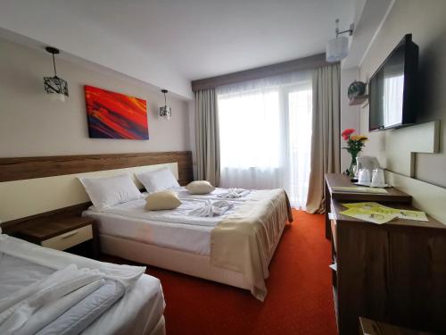 Postel nebo postele na pokoji v ubytování Hotel Olimpic