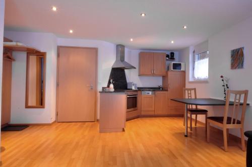 a kitchen with a table and a stove top oven at Haus Shangri-La in Saas-Fee
