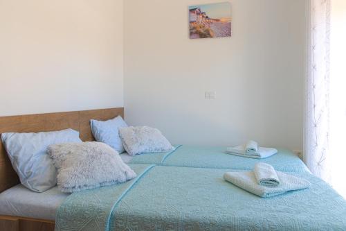 a bedroom with two beds with towels on them at Villa Umag Seafront in Umag