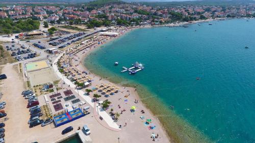 an aerial view of a beach with a boat in the water at Apartments Crljen in Brodarica