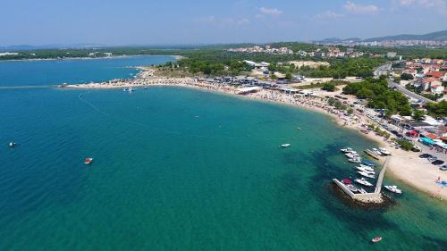 an aerial view of a beach with boats in the water at Apartments Crljen in Brodarica