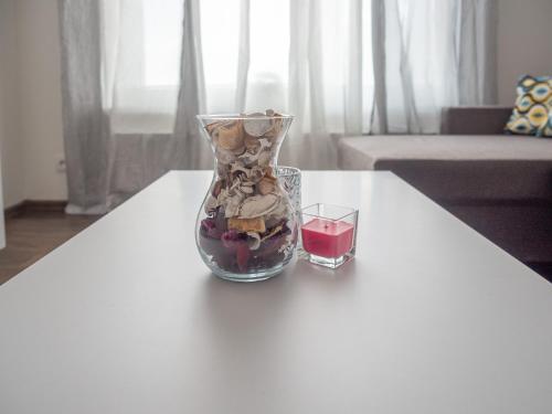 a glass vase sitting on a table with a drink at Relaxcentrum Ľudmila in Cabaj-Čápor