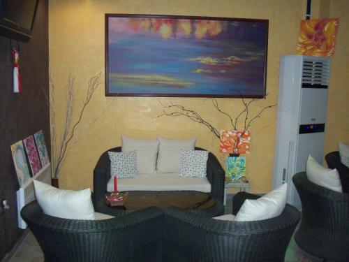 a living room with two chairs and a couch at Семеен Хотел Русалка in Svishtov