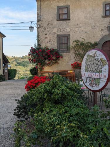 a sign in front of a building with flowers at Agriturismo La Fattoria di Capezzana in Carmignano