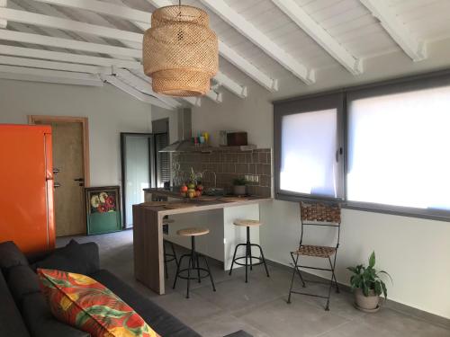 a living room with a couch and a kitchen at Toni’s apartment in Platamonas