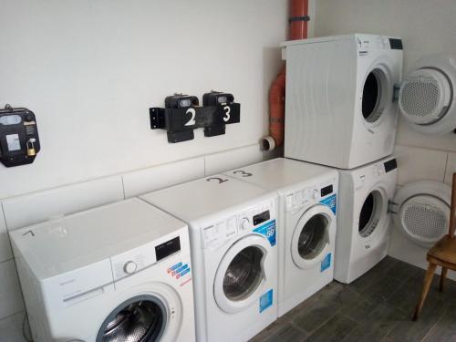 a laundry room with two washes and two machines at Campingplatz Torrenerhof in Golling an der Salzach