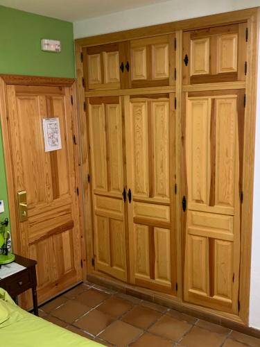 a room with wooden cabinets in a bedroom at Ronda in Ronda