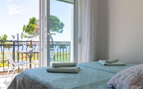 a bedroom with a bed and a large window at Villa Umag Seafront in Umag