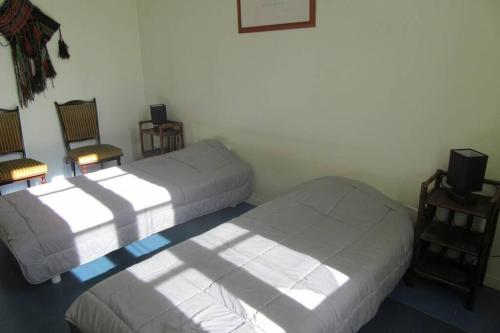 - une chambre avec deux lits et deux chaises dans l'établissement appartement 60m2 dans quartier historique, à Rochefort