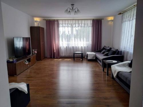 a living room with a couch and a tv at RAMAR in Bodzentyn