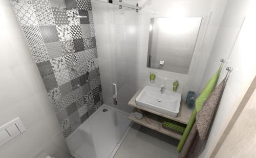 a white bathroom with a sink and a shower at Sport Apartmán DM in Dolní Morava