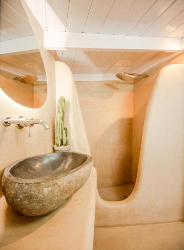 a bathroom with a stone sink with a cactus at The Roof-Top in Megalochori