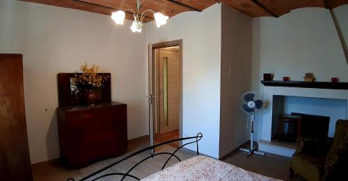 a bedroom with a bed and a fireplace at Appartamenti di Luca&Sara in Le Piazze